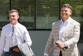Jack Wighton, left, and Latrell Mitchell, are all smiles after their charges were dismissed on Wednesday. Picture by Sitthixay Ditthavong