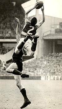 SPECKY: Footscray's Merv Hobbs flies over Melbourne's Trevor Johnson during the 1961 preliminary final Picture: Ron Scorah