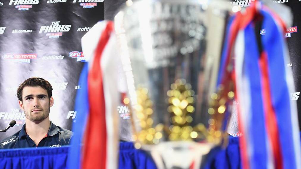 PLENTY AT STAKE: Western Bulldogs stand-in captain Easton Wood and the 2016 premiership cup. Picture: Getty Images.