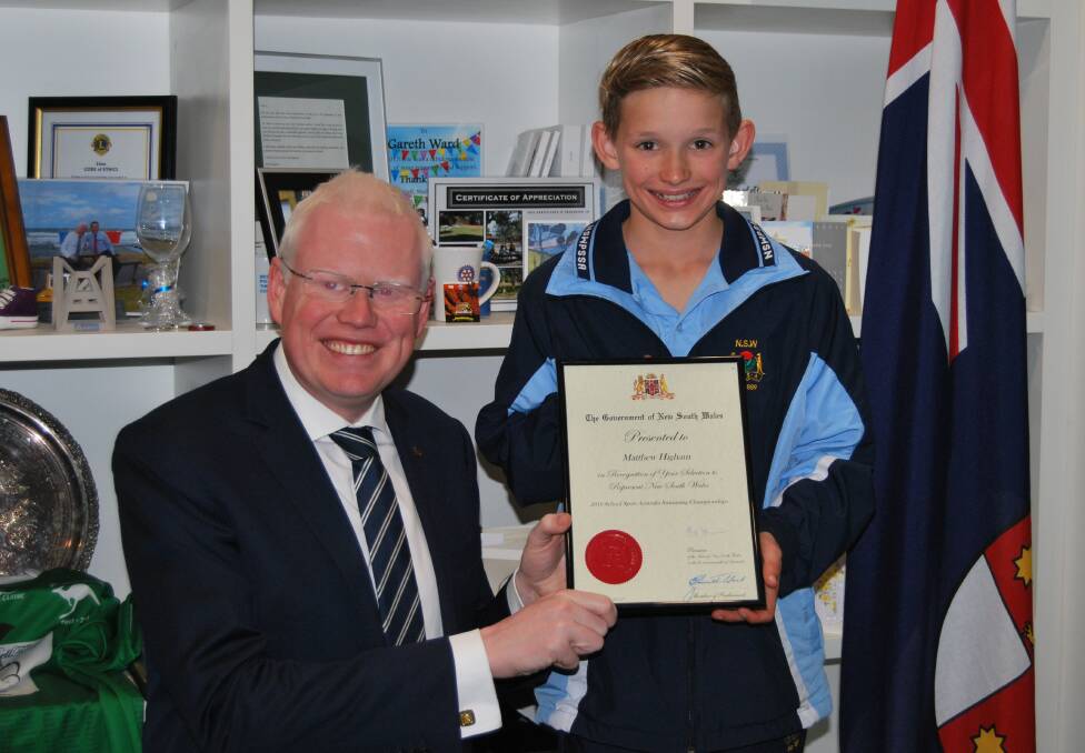 Kiama MP Gareth Ward presents Matthew Higham with an award of recognition for representing NSW at the 2015 School Sport Australia Swimming Championships.