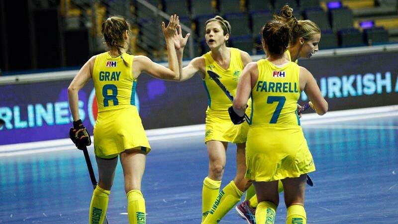 Kyah Gray (left) celebrates a goal with her team mates. Photo: FIH