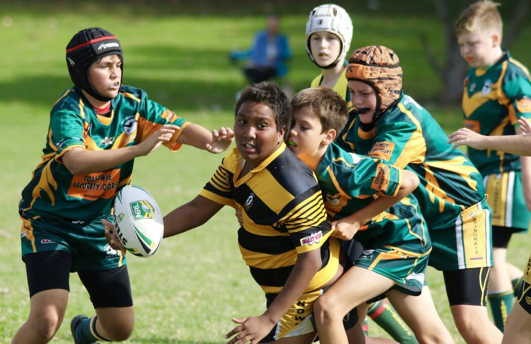 WHAT AN OFFLOAD: Under 12 Warrior Lance Davison gets a pass away during the latest game of junior Group 7 rugby league at the weekend.