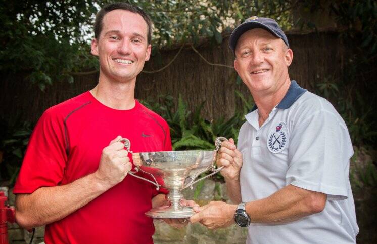 Navy tennis champ: Chief Petty Officer Andrew Gibson hands the Carr Cup to 2017 winner Leading Seaman Tom Holder.  Photo: Bonny Gassner