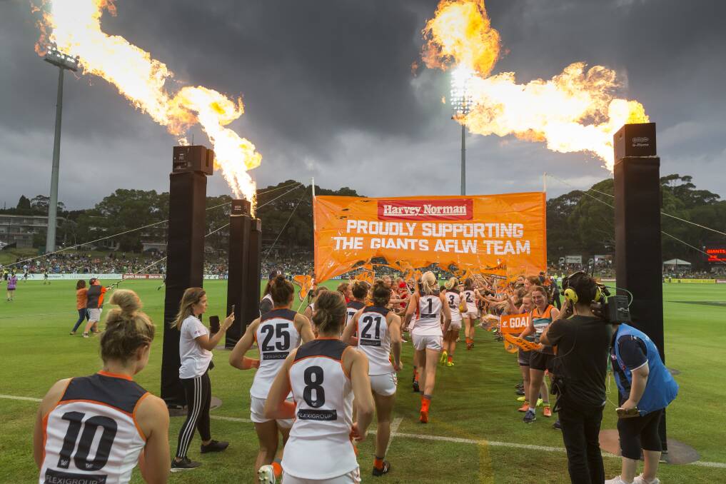 The Greater Western Sydney Giants run onto the field before their round two AFLW match against Carlton at Drummoyne Oval. Photo: Craig Golding 