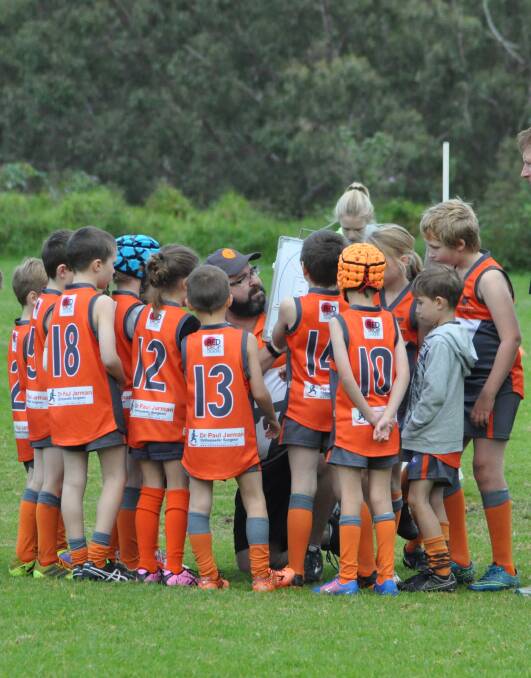 KICKING GOALS: Shoalhaven Giants under 9s coach Tim McNamarra talks tactics with his team during a recent match. McNamarra and Brent Milner (under 11s) are the coaches in 2017. Photo: COURTNEY WARD