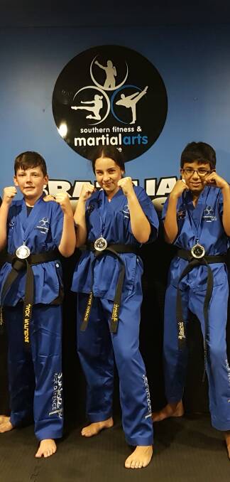 TOP OF THEIR CLASS: Southern Fitness and Martial Arts Centre Bomaderry's three advanced junior black belts following their successful term four gradings.