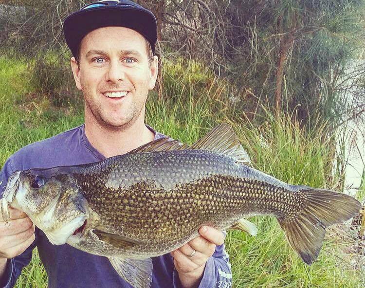 Local angler Blake Fallon with a stonker (54.5cm) of a South Coast bass. Jonno reckons bass, estuary perch, snapper and flathead are all biting.