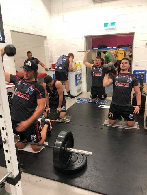 Jess Dee (back) trains with his Mackay Cutters team mates.