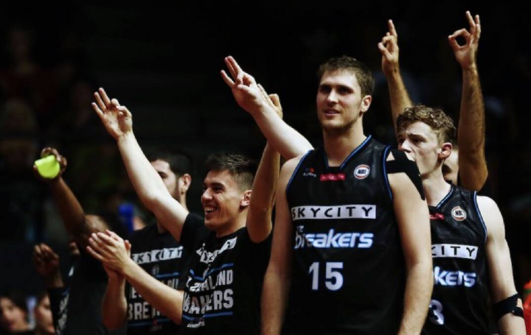 James Hunter and his New Zealand team mates celebrate on the bench. Photo: NEW ZEALAND BREAKERS