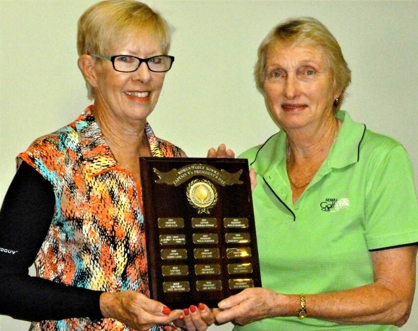 Nowra Women's Golf captain Jenny Brown accepting the Captain v President Trophy from president Sue Stephens