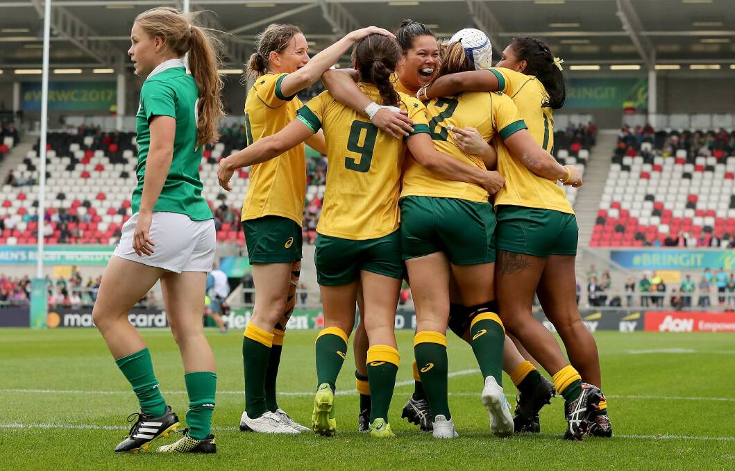 Ashleigh Hewson (left of huddle) with her Wallaroos team mates. Photo: WORLD RUGBY