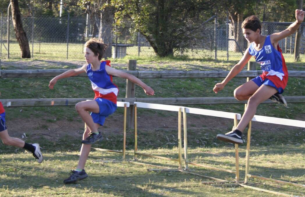 OVER THE TOP: Shoalhaven Little Athletics Club's Tallen Scott and Taj Hart battle each other during a recent hurdles race held by the club.