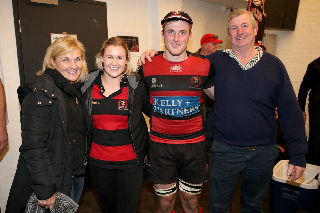 Will Miller in his Norths 100-game hat with mother Jennifer, wife Savanagh and father John. Photo: Clay Cross/SPORTSPICS