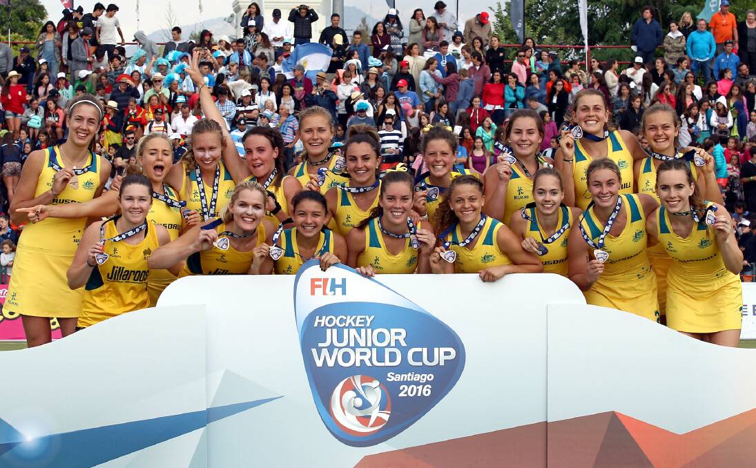 HARD WORK PAYS OFF: Grace Stewart (front and centre) and her Jillaroos team mates celebrate with their Junior World Cup bronze medals after defeating Spain in a shoot-out. Photo: World Sports Pics