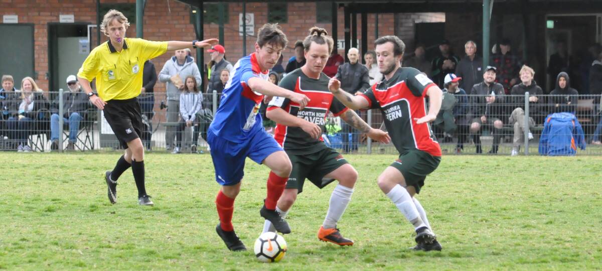 CONTROL: Breakers' Jake Packham, who scored his team's fourth goal, avoids the attention of two Illaroo defenders on Saturday. Photo: DAMIAN McGILL