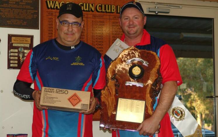 SHOOTING FOR THE STARS: Steve Atkins (right) accepts his award as High Gun (overall top shot) of the ADF Clay Target Association Interservice Carnival.
