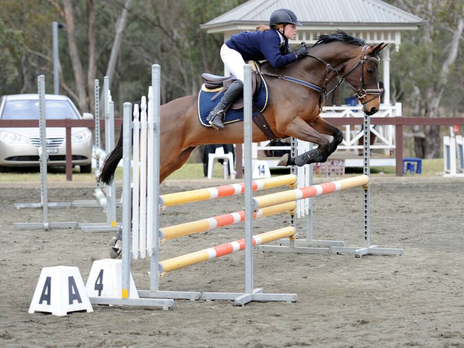 PRECISION: Kangaroo Valley Public School's Aria Baker and her horse Persuasion are the current NSW Primary Champion for showjumping. Photo: OZ SHOTZ