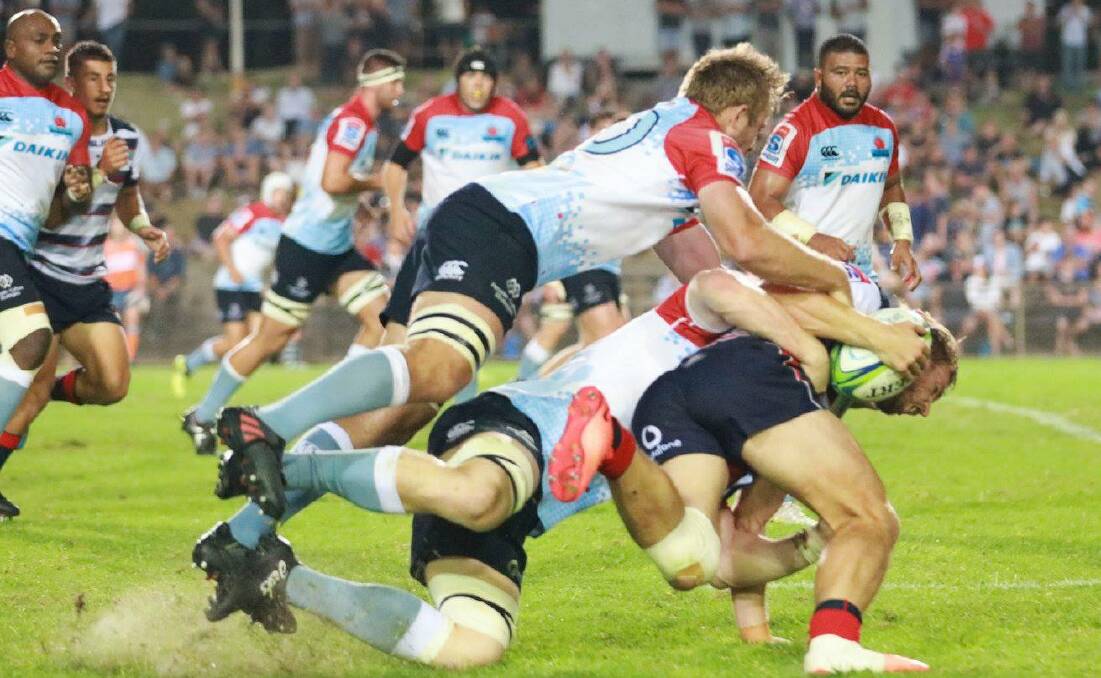 New South Wales' Will Miller (20) makes a tackle against the Melbourne Rebels on Thursday night. Photo: NSW WARATAHS MEDIA