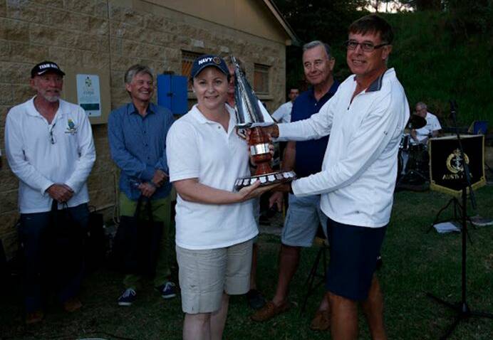 Navy champions: Jervis Bay Cruising Yacht Club members hand over the Creswell Cup to Creswell/Albatross Sailing Club. Photo: Kel Hockey