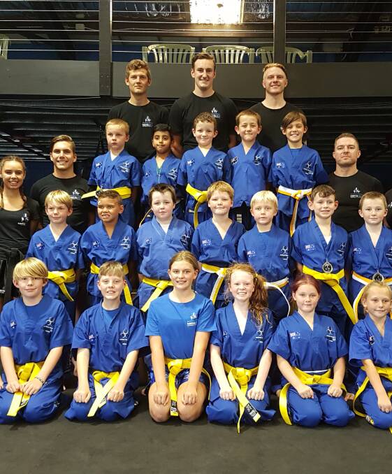 STOKED: Southern Fitness and Martial Arts Centre Bomaderry's beginner juniors kick defence after their recent term four gradings.