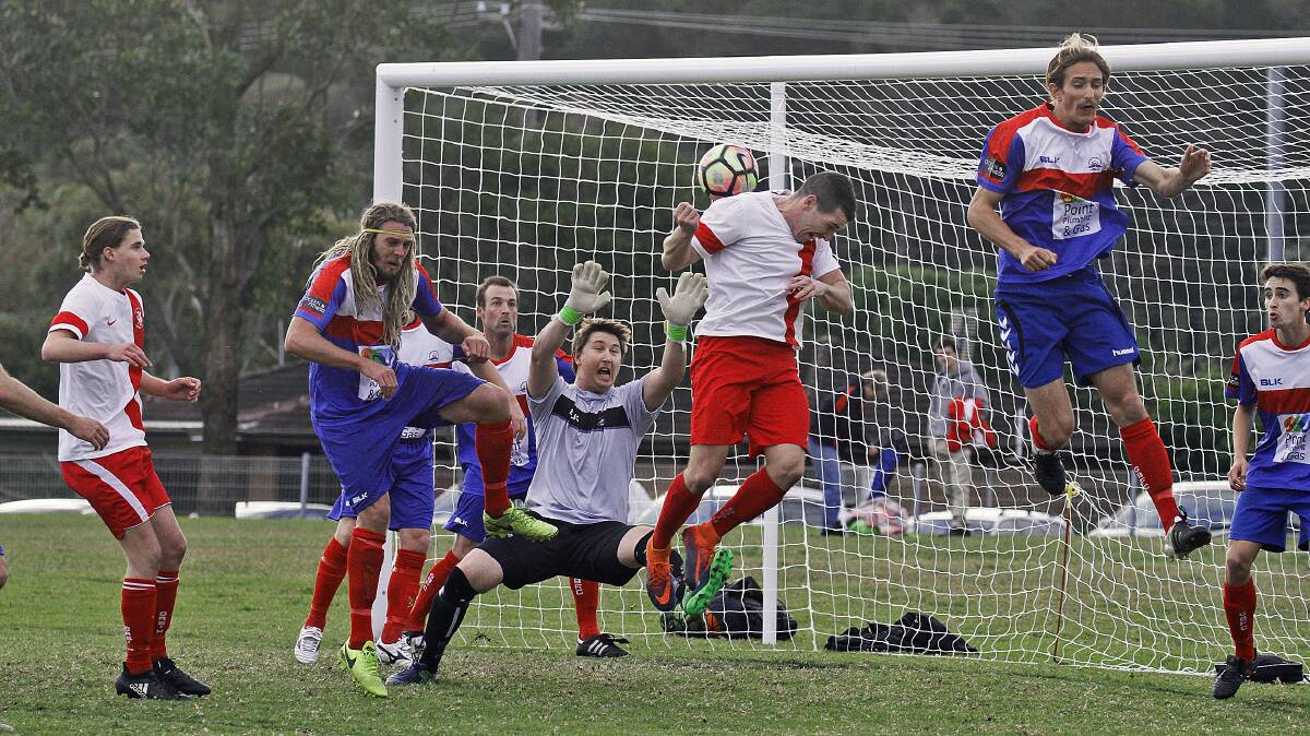 CLASH: Gerringong's goalkeeper Joel Lockard saves his team from a dangerous corner kick against Basin. Photo: GAME FACE PHOTOGRAPHY