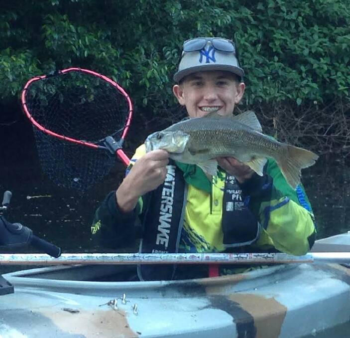 WHOSE SMILE IS BIGGER: Shoalhaven's Jack Shackelton shows off the sneaky creek bass that he caught recently while kayaking.