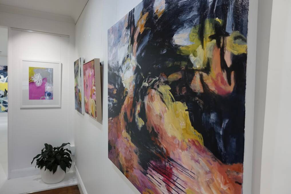 Unique: A group of artists exhibiting works (left) linked by colour as the common theme at Fern Street Gallery.