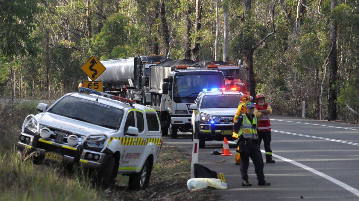 CRASH SCENE: Emergency workers attend Friday's accident on the Princes Highway. They are among many people whose lives are affected by road trauma while governments bicker about funding. Photo: Damian McGill