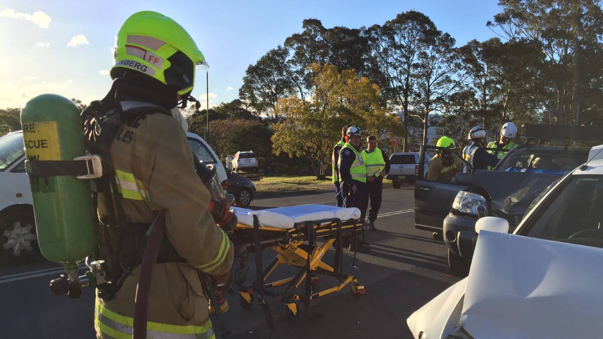 CRASH SITE: Emergency services personnel at the scene of accident on the Princes Highway near Douglas Street at Nowra.  