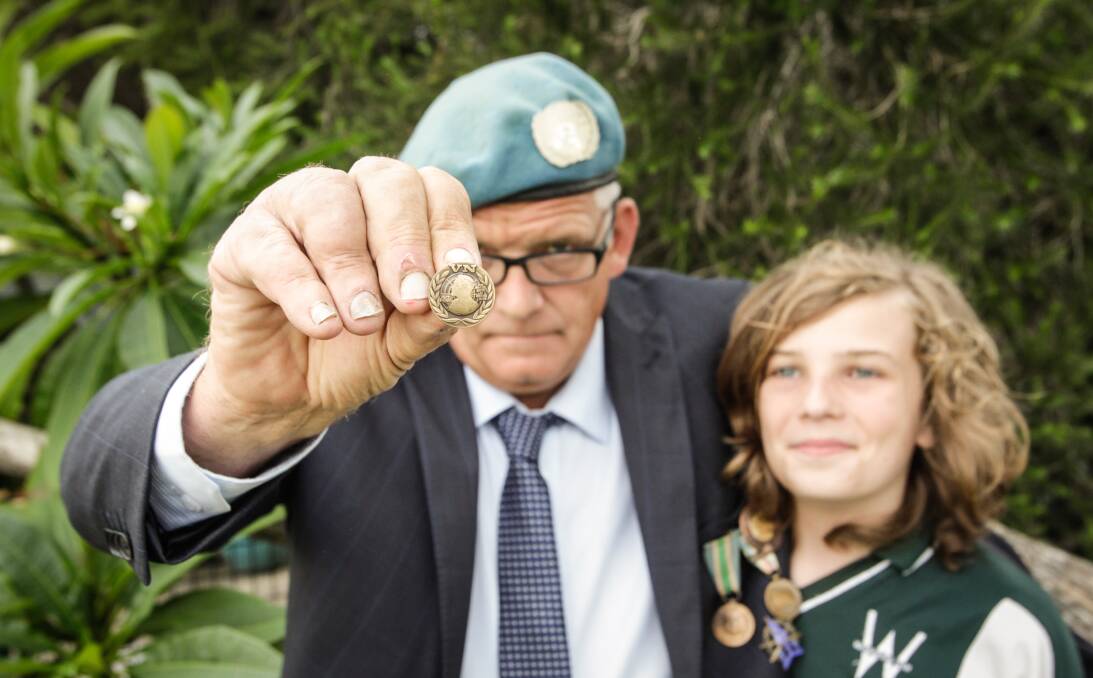 medal-winner: Cringila's Nobel Peace Prize recipient Henk Haasjes - with his son James Haasjes - shows off the medal he was awarded on Thursday night. Picture: Georgia Matts