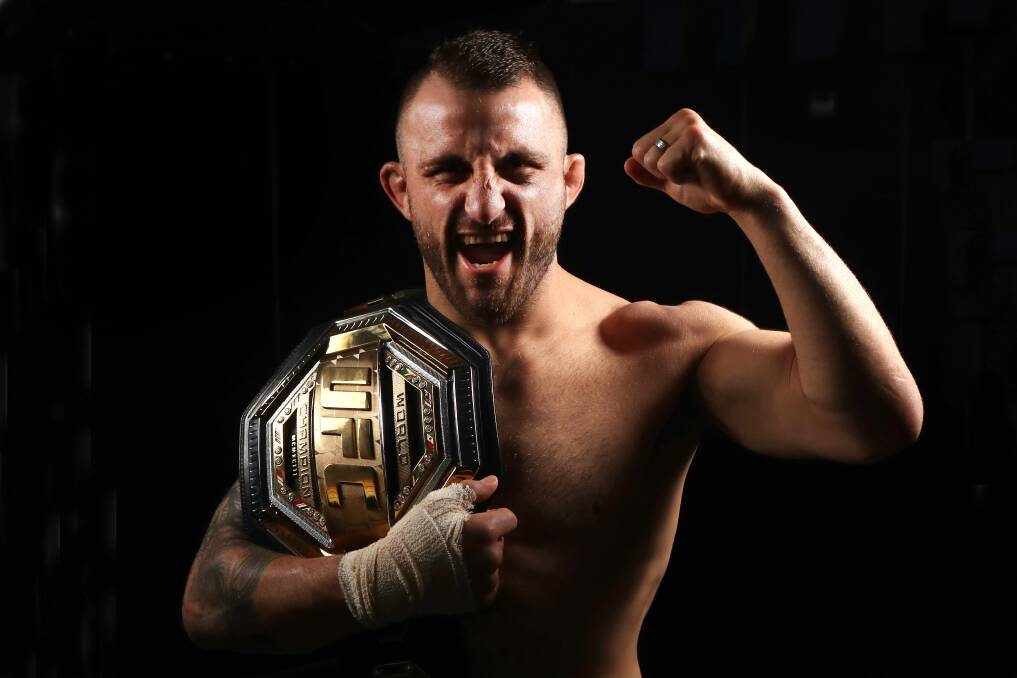 Alexander Volkanovski holds up his UFC featherweight title belt. Photo: Sylvia Liber