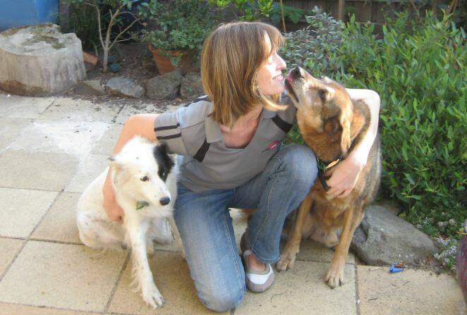 ANIMAL LOVER: Lonely Pets Club director Jo Gault gets a friendly lick from Rusty.
