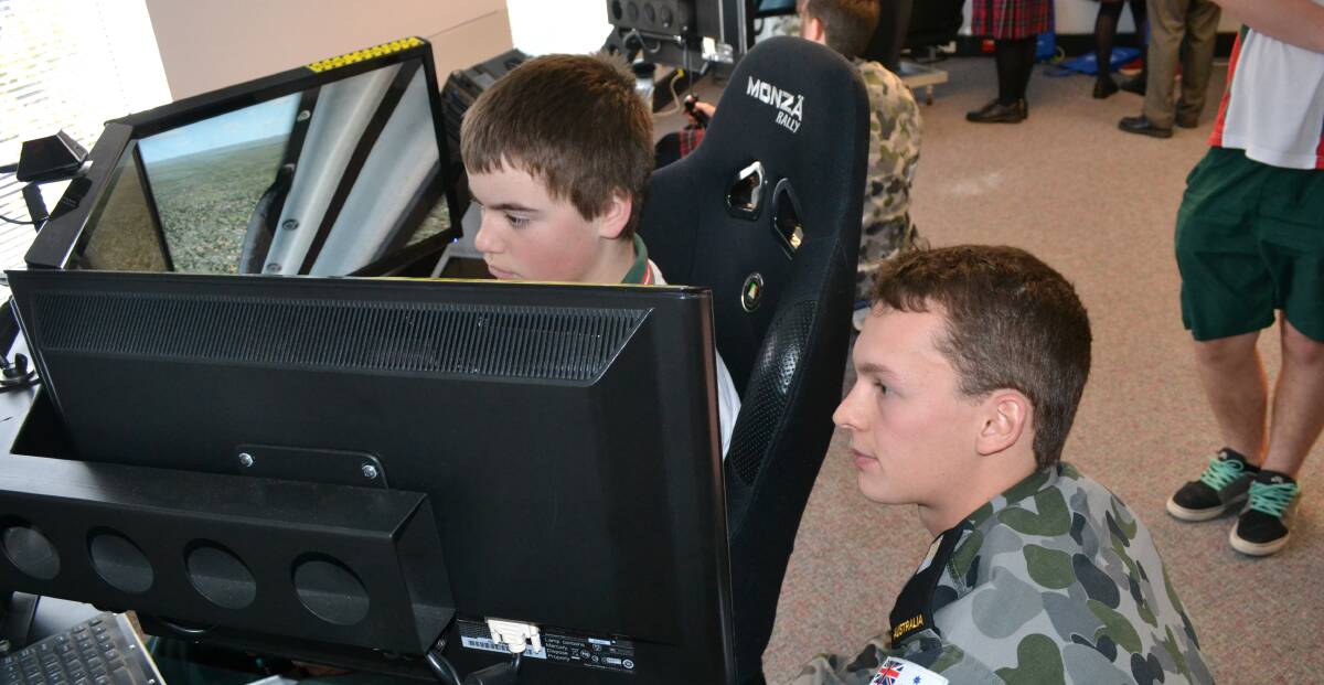 TEST ENVIRONMENT: David Falge from Bomaderry High School tests out a simulator with Midshipmen Joshua Gorrie from HMAS Albatross at a past expo.