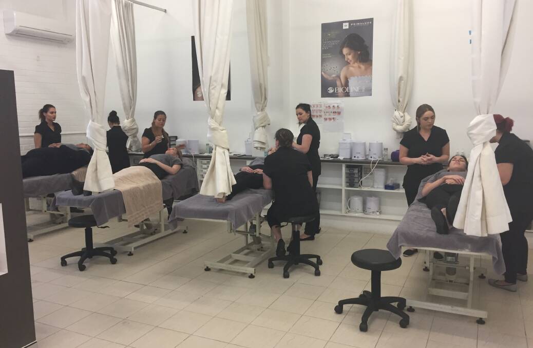 PAMPER TIME: Shoalhaven Community College students in training perform eyelash treatments on clients as part of their accredited qualifications.