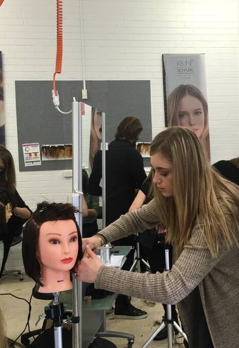 PRACTICE MAKES PERFECT: A Shoalhaven Community College student in training learns how to cut hair as part of her accredited qualification.
