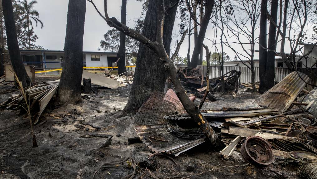 The back fences of properties in Lake Tabourie show the scars of a bushfire that moved through on Thursday afternoon. Picture: Sitthixay Ditthavong

