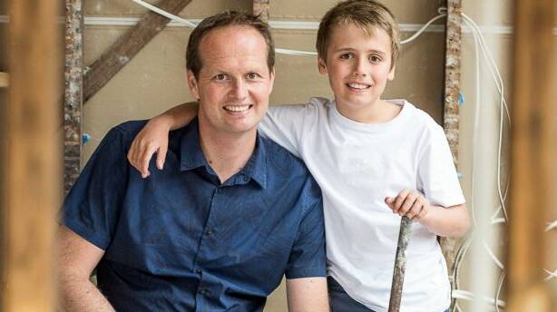 Scott Moffat with his son during the renovation. Photo: Supplied
