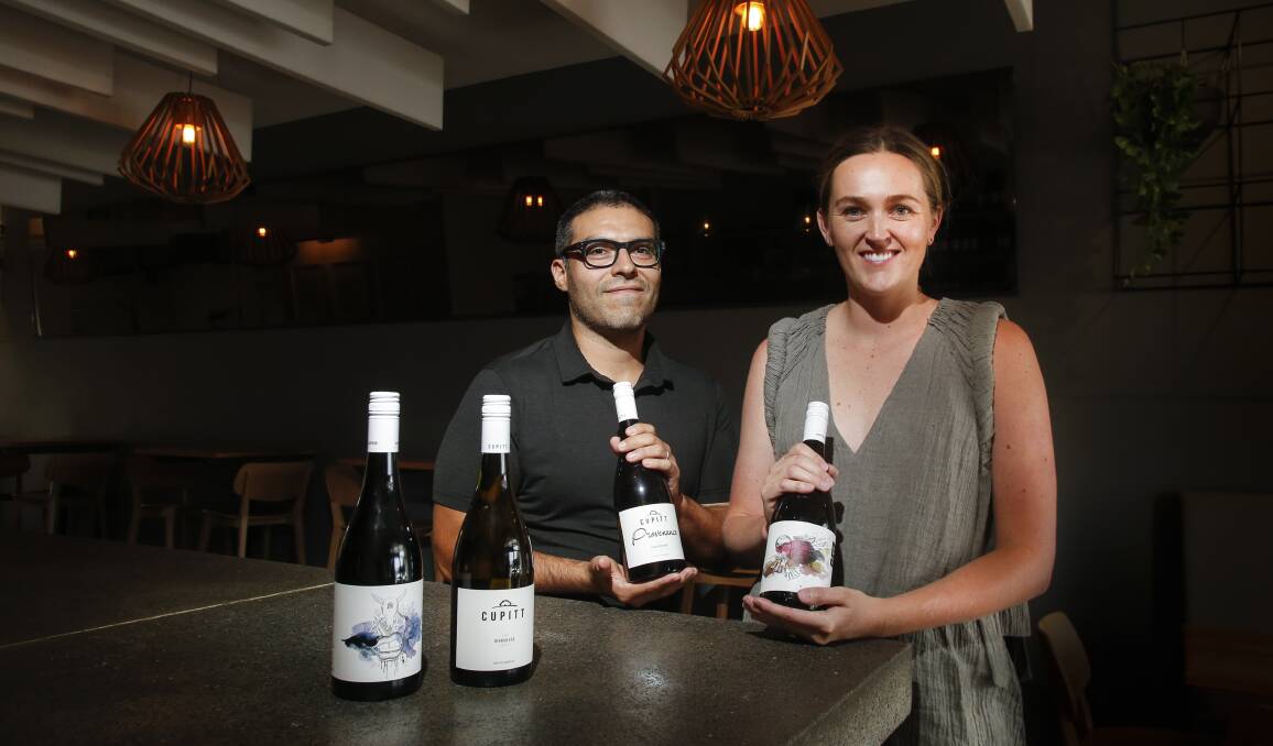 Cash injection: Throsby wine bar owners Erick Zavallos and Maddie Sullivan changed their menu last weekend to sell only wines from fire-affected businesses. Picture: Anna Warr.