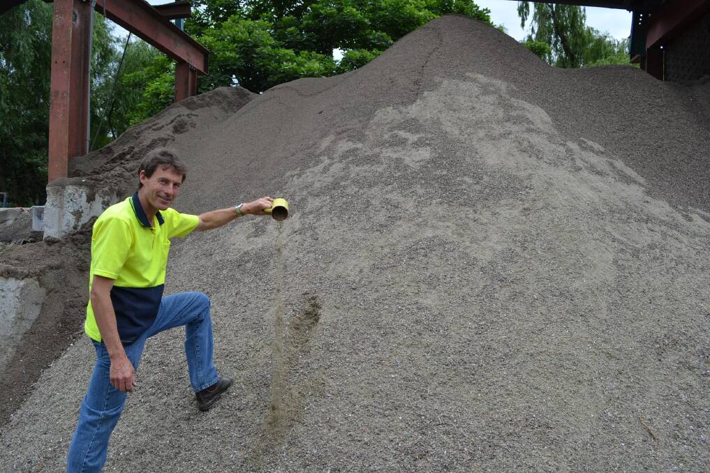 Reuse: Shoalhaven Recycling project manager Stephen Willis shows how broken glass can be recycled into a sand-like product used in local construction works. Photo: Jessica Long
