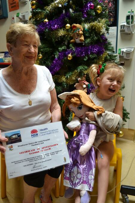 Merry Christmas: Ward Grandparents Program member Rosemary Grocott and Shoalhaven Hospital Children's Ward patient Halle Wellings. Photo: Jessica Long