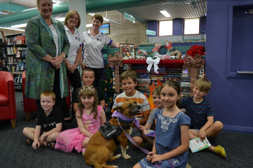 Celebration: Paws and Tales program participants celebrated with reading buddy Beau, Gilmore MP Ann Sudmalis and Sharon Stewart and Lisa McKay from Paws and Pet Therapy. Photo: Jessica Long