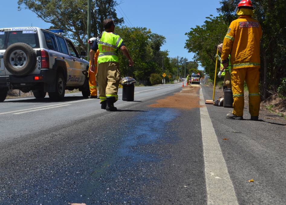 Fire crews mop up the mess at Main Road, Cambewarra, on Tuesday afternoon. Picture: Rebecca Fist