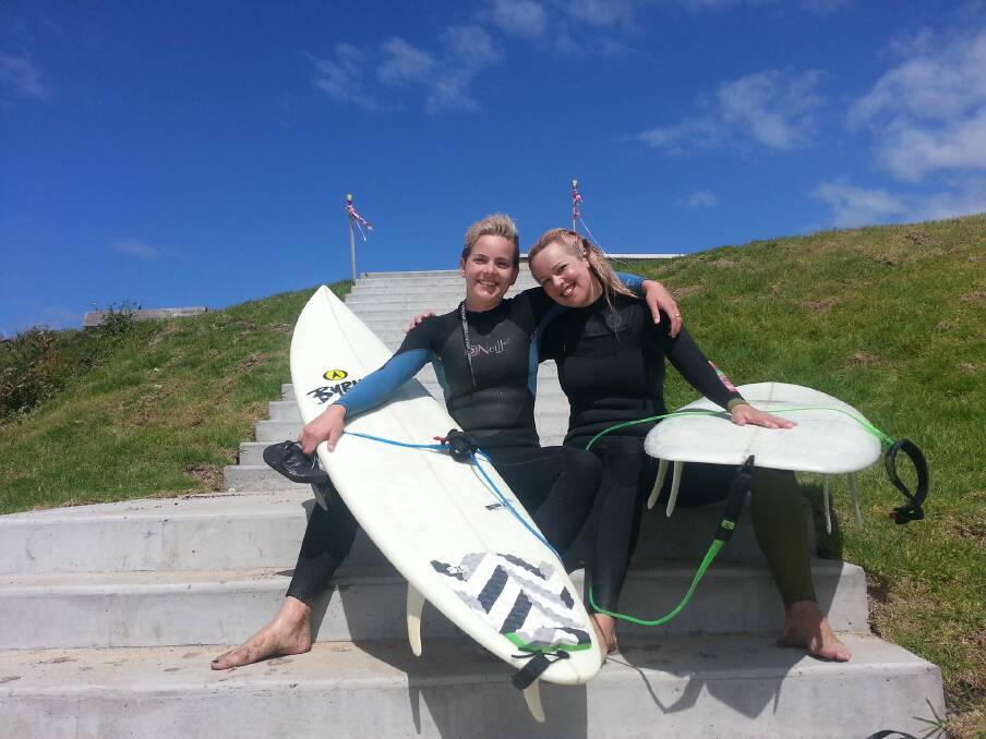 BETTER TOGETHER: Columnist Rebecca Fist and her sister Katie Polyblank heading out for a surf together during winter.