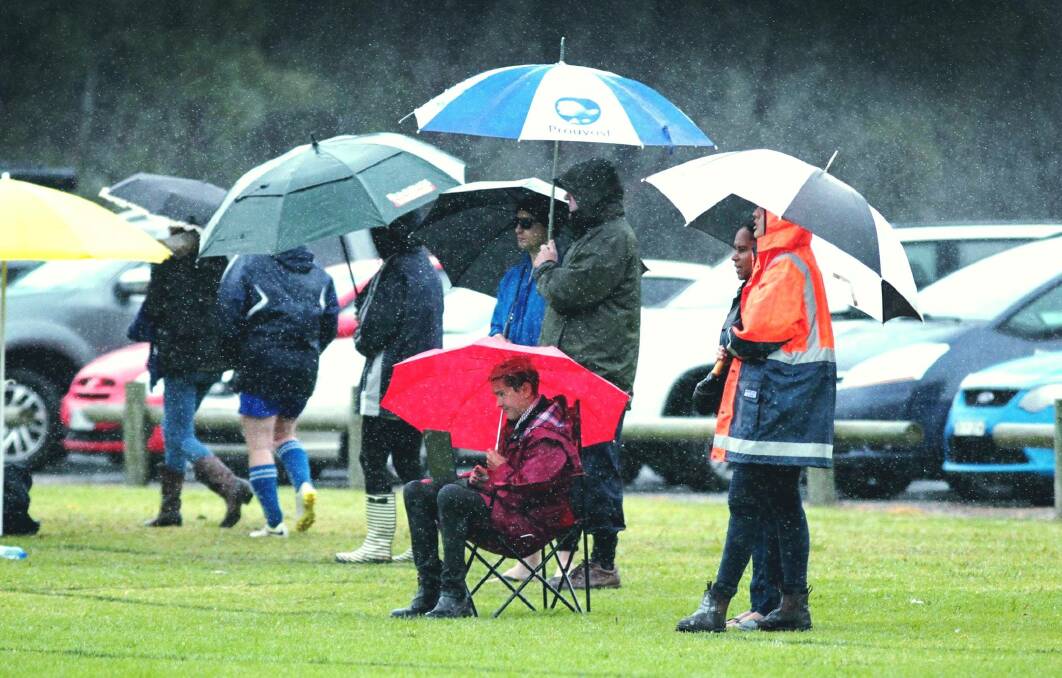 Journalist Rebecca Fist, in her capacity as a sports reporter at Wagga, braving the elements to write about the Football Wagga women's competition in 2016
