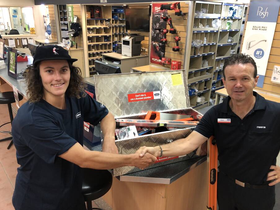 Apprentice plumber Riley Watson, taking on some tools from Martin Butterworth of Reece Plumbing, Central Nowra.