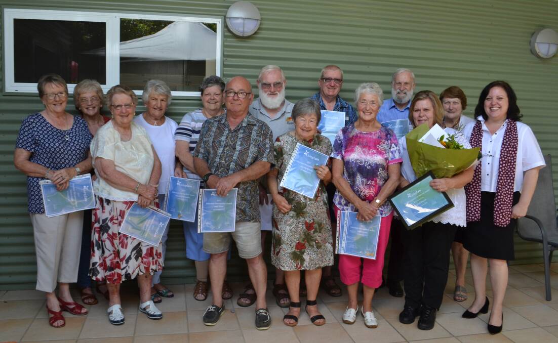 Volunteers and workers at Clelland Lodge acknowledged for their outstanding efforts this year by Living Care executive director Natalie Cook (right).