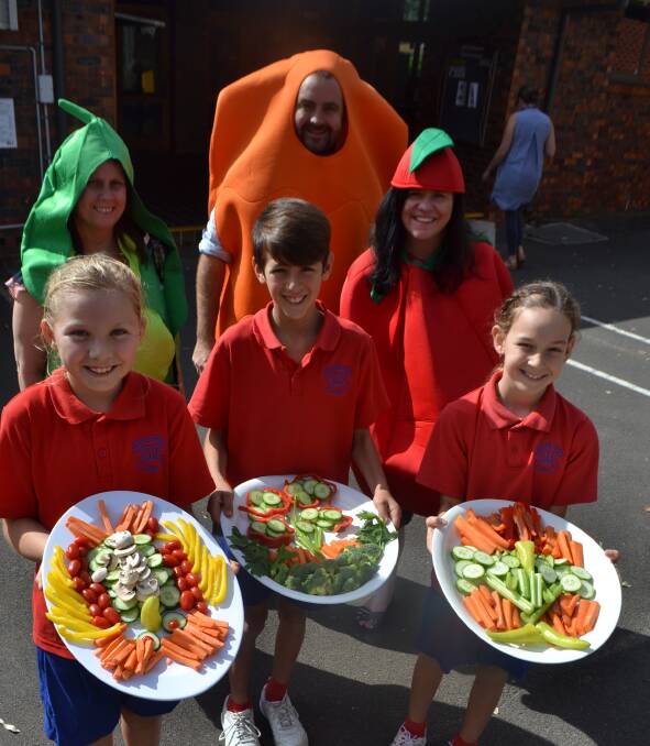 FEAST: St Michael's Catholic Primary School students Abbey Poulton, Jullian Gentile and Madeleine Coleman and teachers Renee Macguire, Anthony Hunt and Toni Hodges on Thursday. Picture: Rebecca Fist