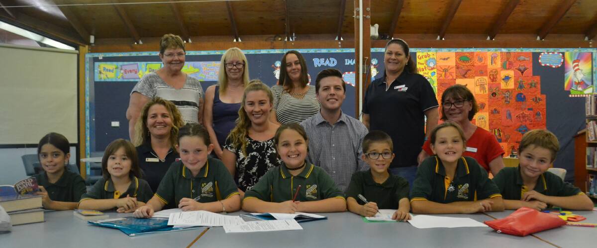 Smith Family's Suanne Sneddon, Ann Green and Donna Braddick, Shoalhaven and districts Law Society Paul Ell and Elspeth Finney, and volunteers Adele Anderson, Janette Trolan and Colleen Gablonski with East Nowra school kids at the after school program on Wednesday. Picture: Rebecca Fist