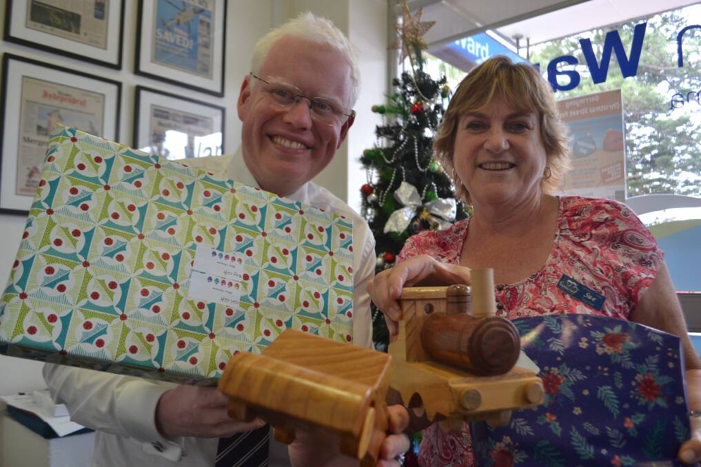 Kiama MP Gareth Ward and Sue Redman from Noah's Ark with a few of the gifts on Friday. Picture: Rebecca Fist