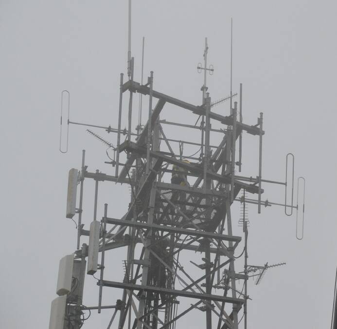 Contractors battled rain and mist as they worked to remove the old telecommunications tower from Cambewarra Mountain.
